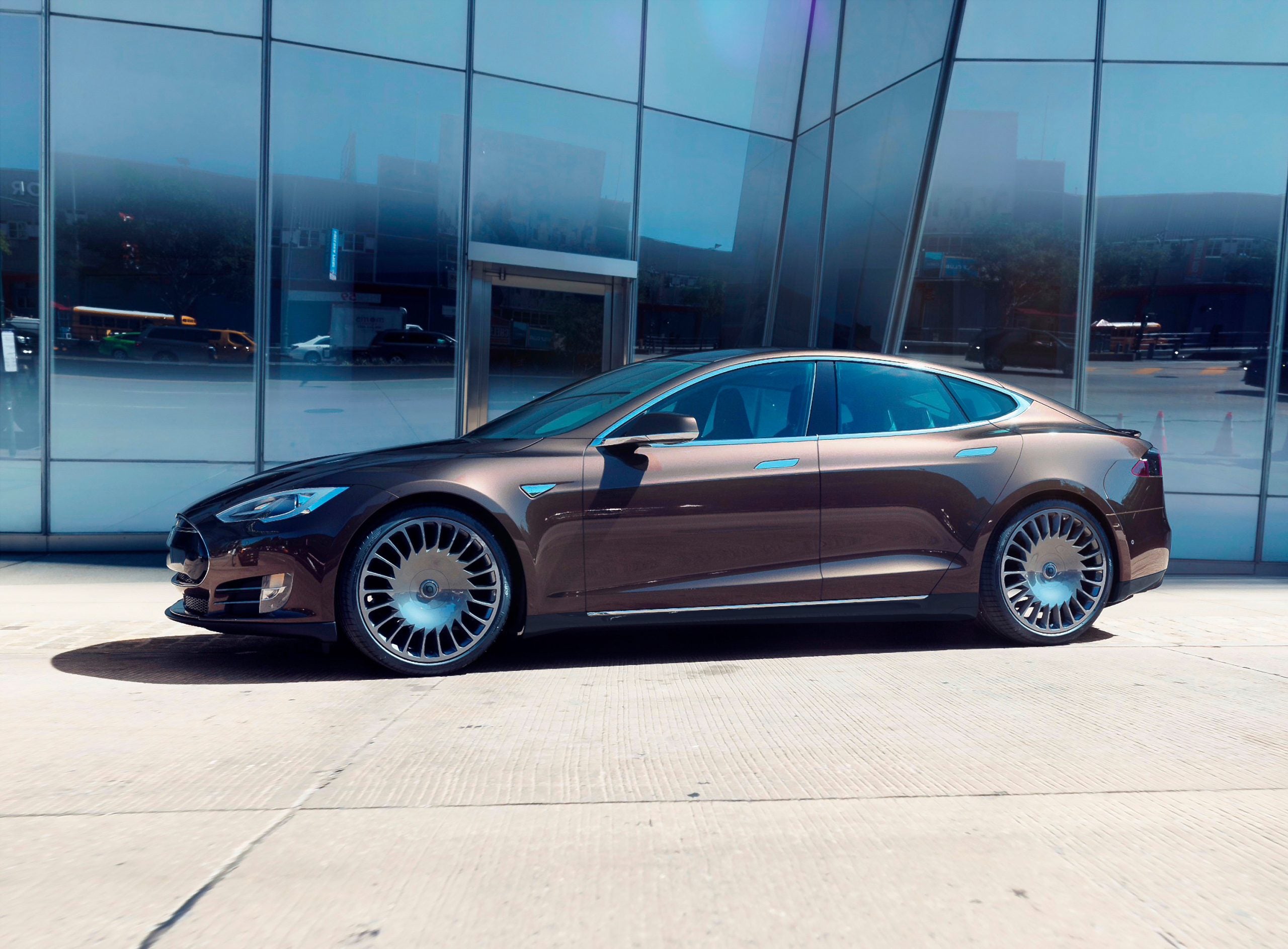 Wheelsboyselect TNA Tesla wheels on brown Tesla sedan, 2020 Red Dot award-winning luxury EV rims with sleek aerodynamic design.